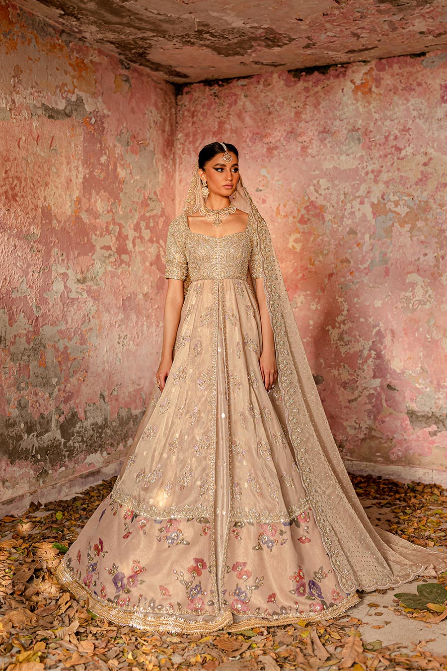 Model wearing a blush pink masuri and organza zari bridal dress by Zuria Dor with front slit pishwas