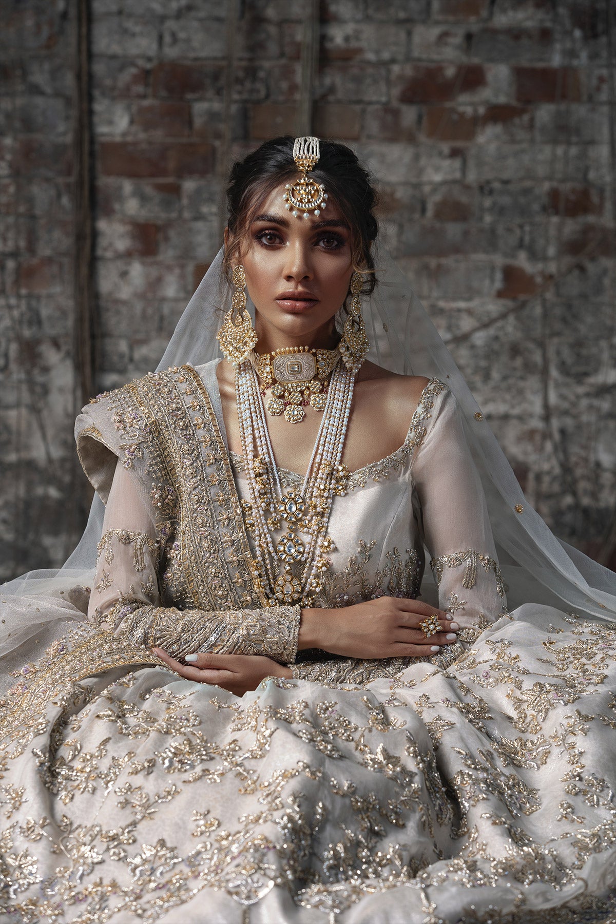 Aidaah Sheikh in a closeup shot wearing ivory gown with zardozi and sequin work all over paired with a zari net dupatta