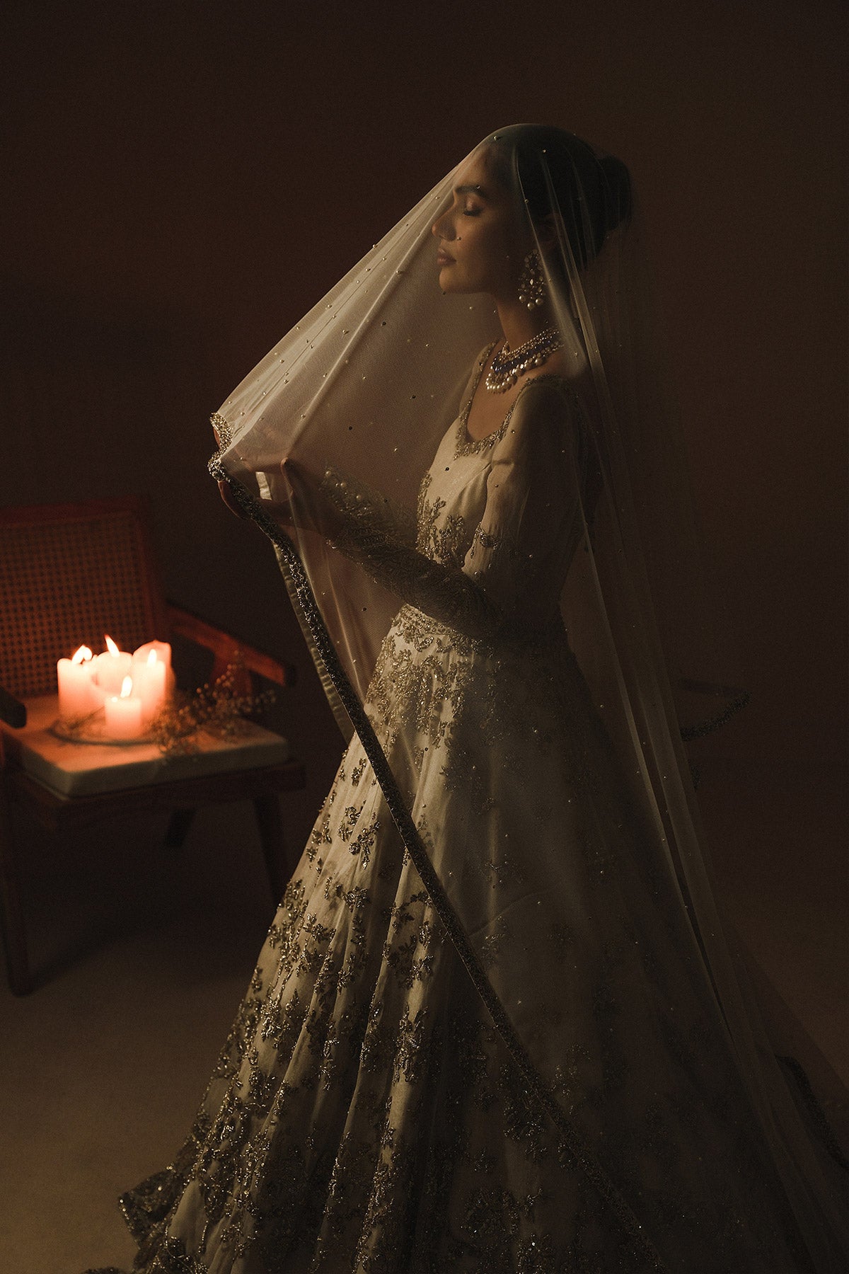 Aidaah Sheikh in a side shot wearing ivory gown with zardozi and sequin work all over paired with a zari net dupatta