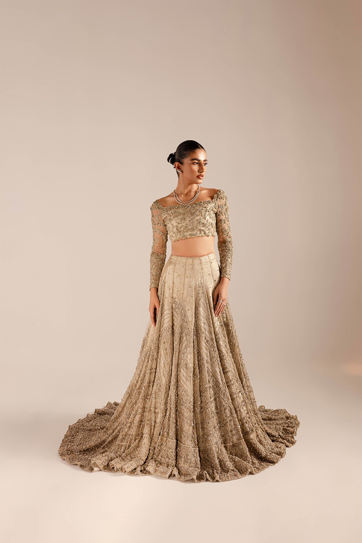 Model in a front shot wearing a kundan net lehenga and choli