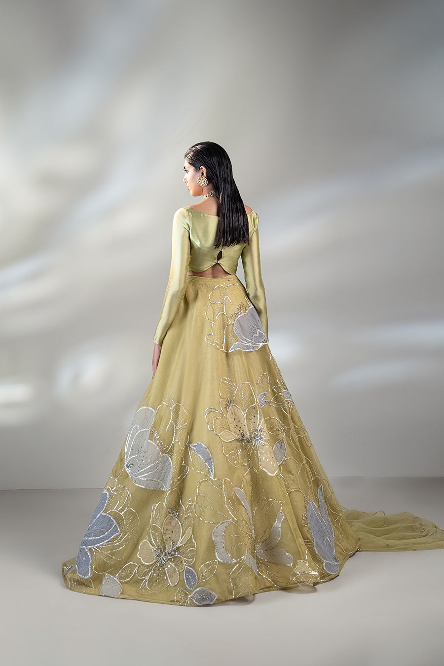 model in a close up shot wearing a formal lime green lehenga paired with a solid choli and dupatta