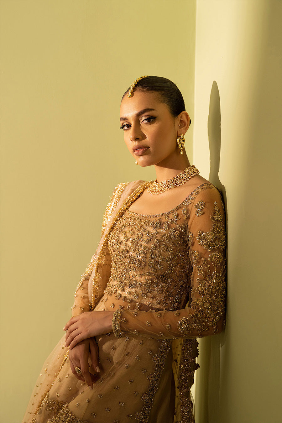 Model in a closeup shot wearing nude pink organza shirt paired with gharara and net dupatta
