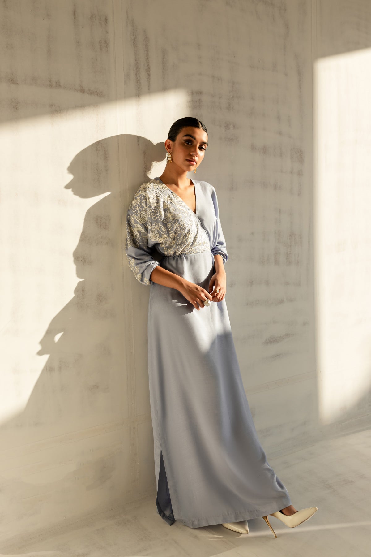 Model in a front side view shot wearing a sky blue embroidered kaftan