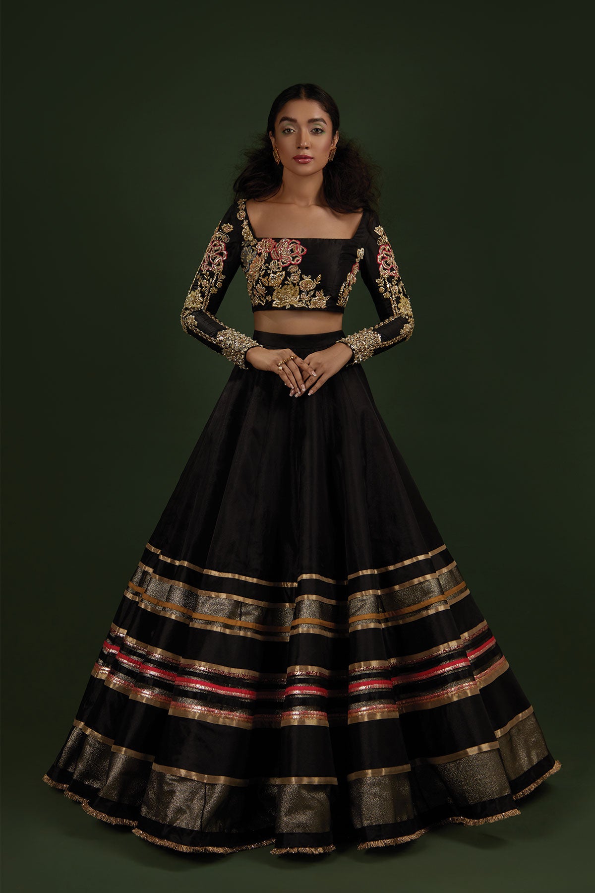 Model in a front shot wearing black lehenga choli made of katan silk paired with a black lehenga