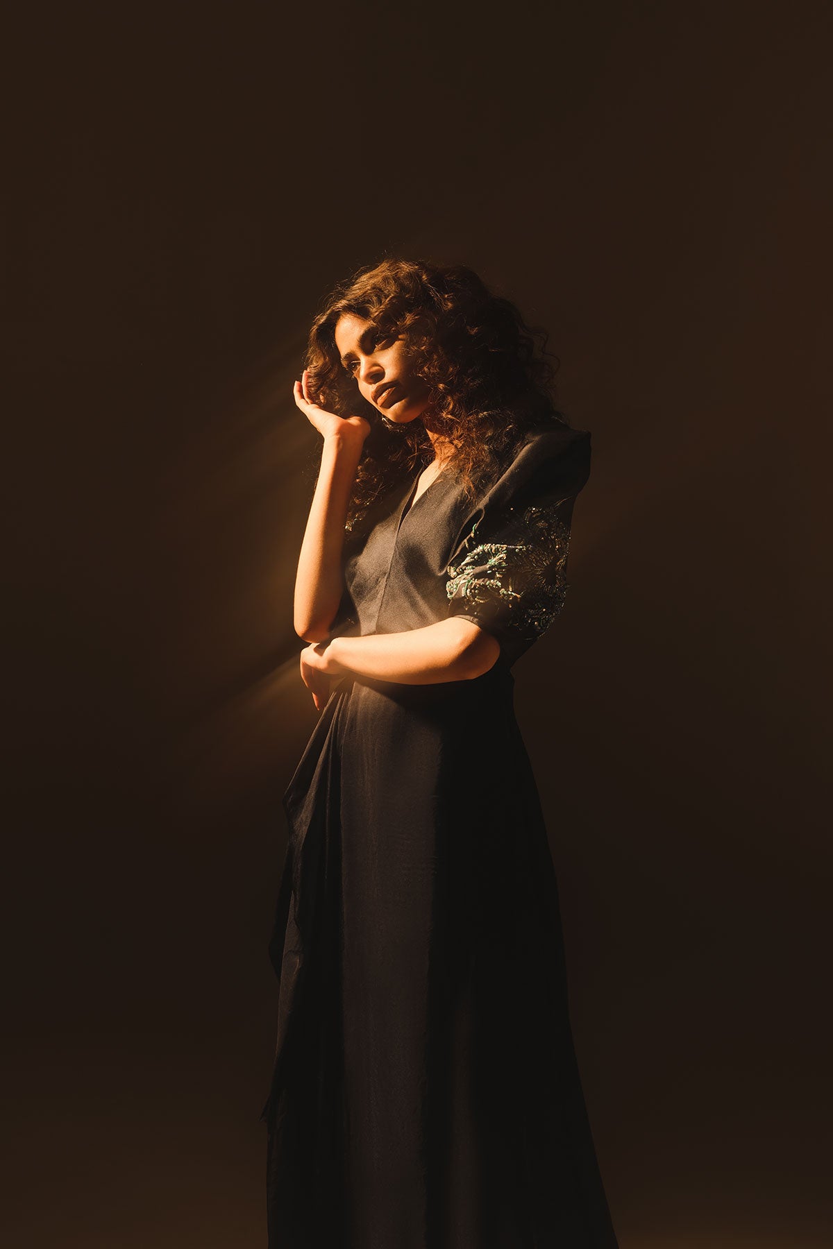 Model in a front side shot wearing a silk chiffon midnight blue dress paired