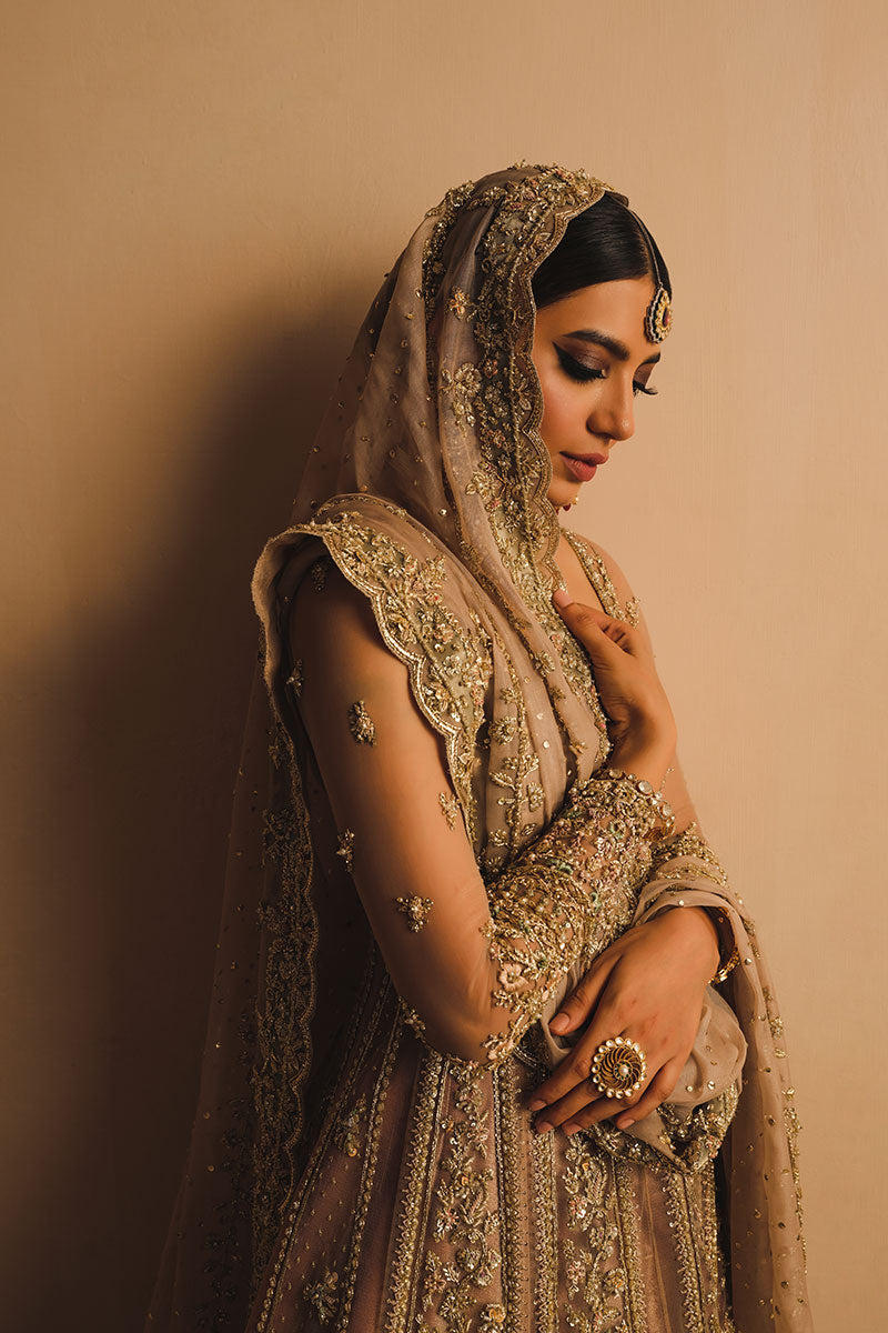 Rabia Butt in a closeup side shot wearing dusty pink net pishwas combined with a farshi sharara and silk organza dupatta