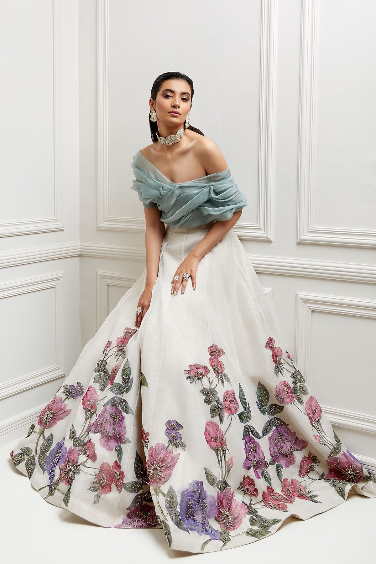 model in a front shot ivory, hand-painted floral organza skirtp aired with an off-shoulder organza blouse