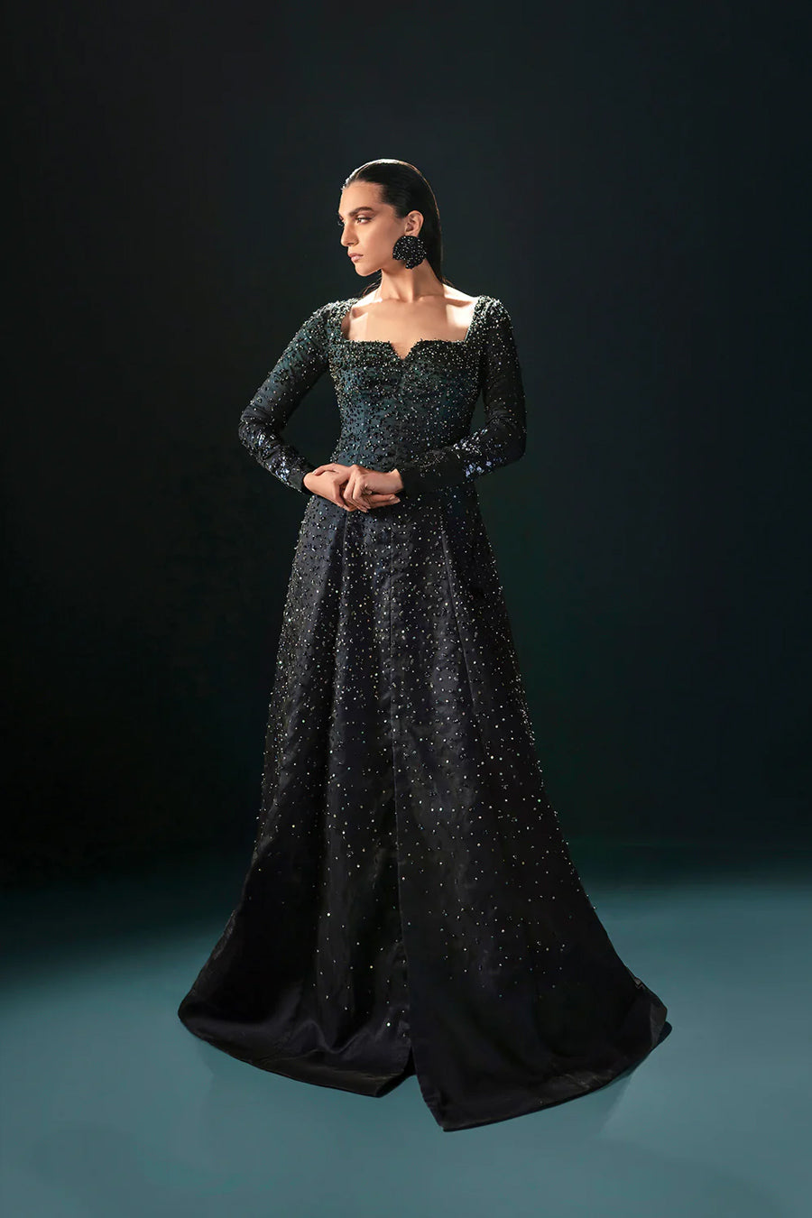 Model in a front shot wearing a formal black front-slit open gown made of organza