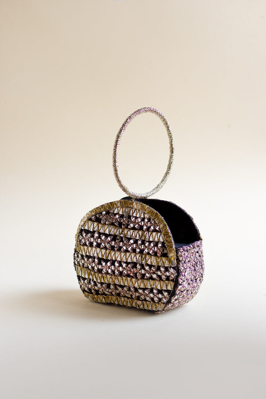 Full shot of silk kattan pouch with mirror work, metallic thread, and gotta stripes