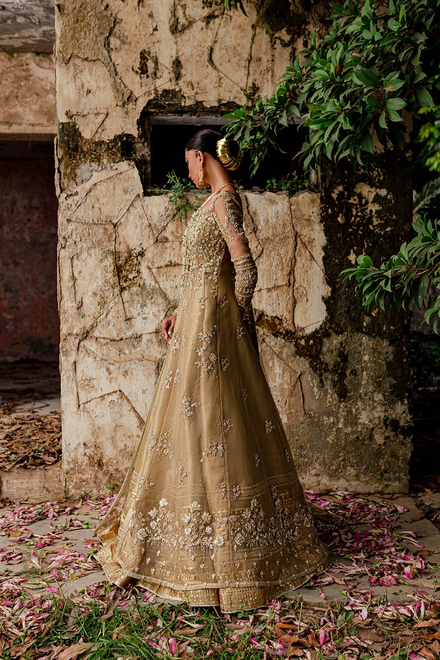 Model wearing a golden front slit organza with zardozi and gota detailing bridal dress by Zuria Dor with front slit shirt