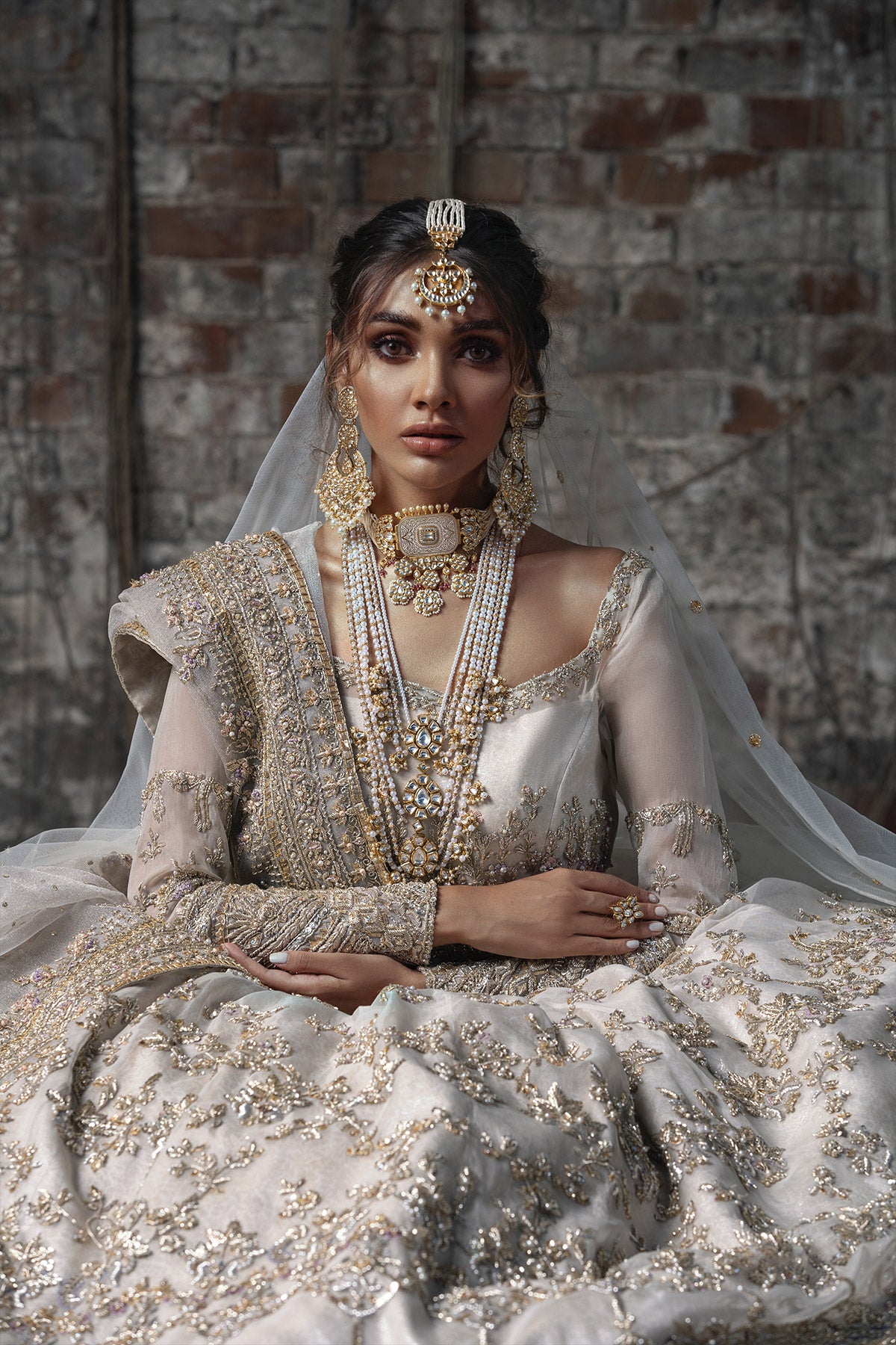 Aidaah Sheikh in a closeup shot wearing ivory gown with zardozi and sequin work all over paired with a zari net dupatta 