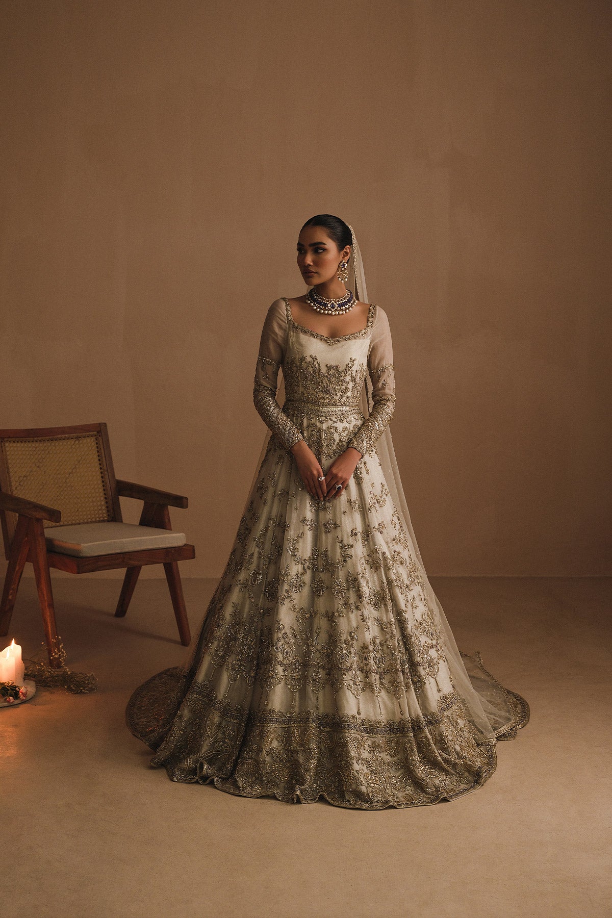 Aidaah Sheikh in a front view shot wearing ivory gown with zardozi and sequin work all over paired with a zari net dupatta 