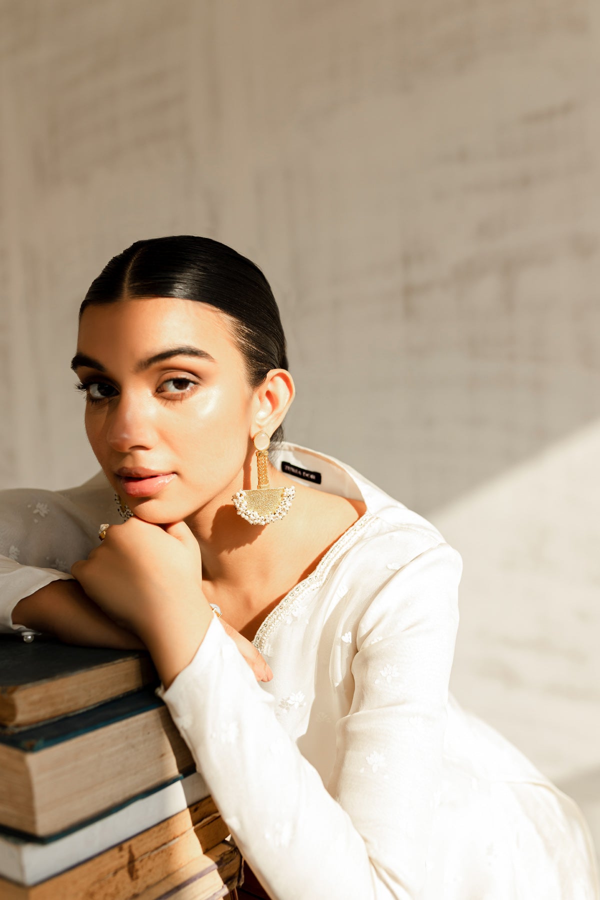 Model in a seated front view shot wearing an ivory organza shirt