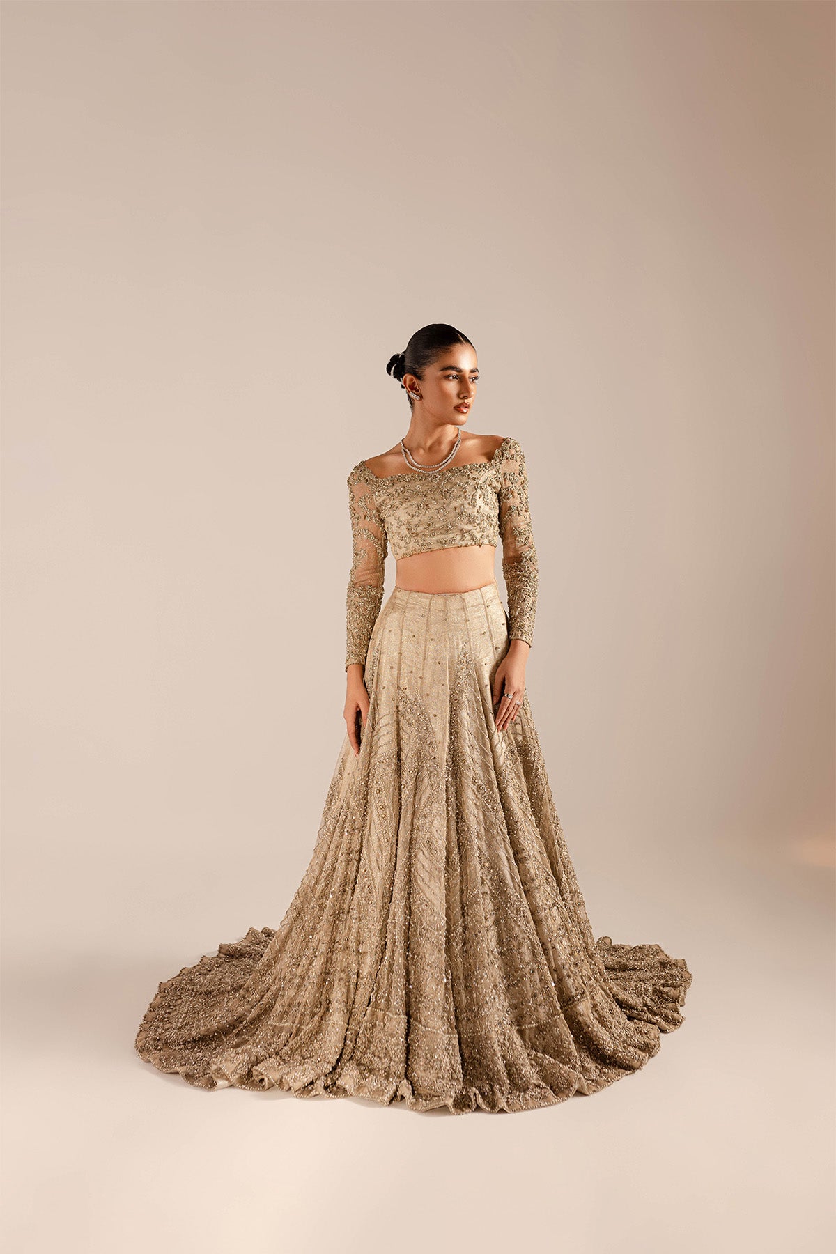 Model in a front shot wearing a kundan net lehenga and choli 