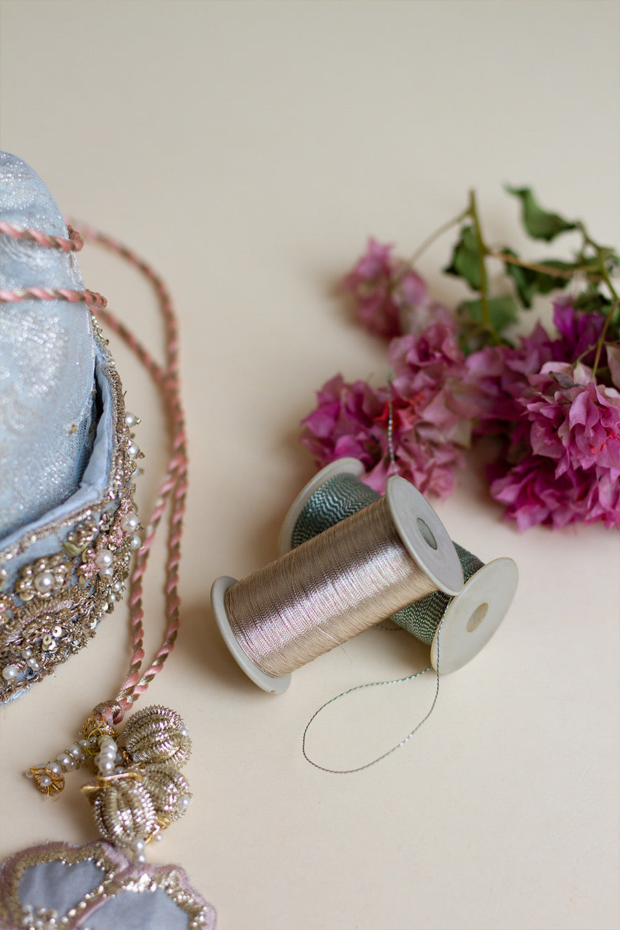 Closeup shot of light blue floral, zardozi and ball tassels