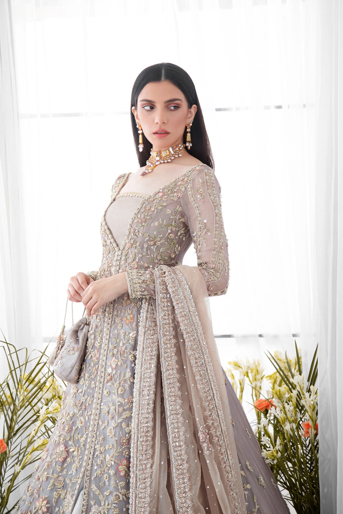 model in a close up shot  wearing bridal paneled lilac tissue shirt paired with a shimmer tissue lehenga along with an organza dupatta 