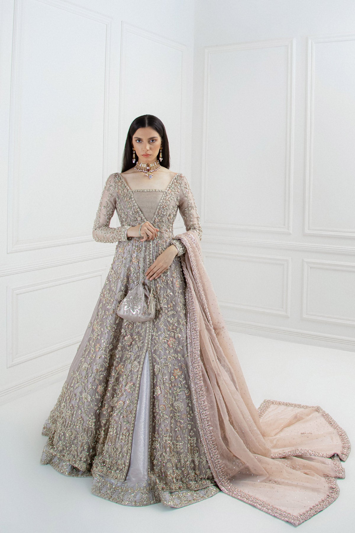 model in a front shot wearing bridal paneled lilac tissue shirt paired with a shimmer tissue lehenga along with an organza dupatta 