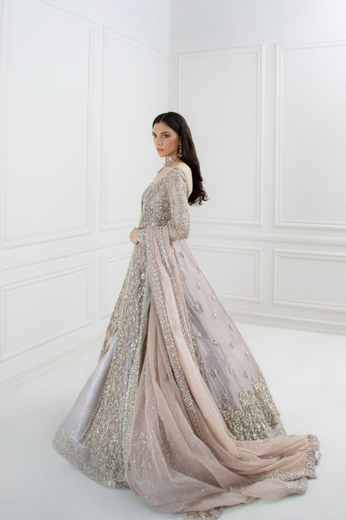 model in a side shot wearing bridal paneled lilac tissue shirt paired with a shimmer tissue lehenga along with an organza dupatta 
