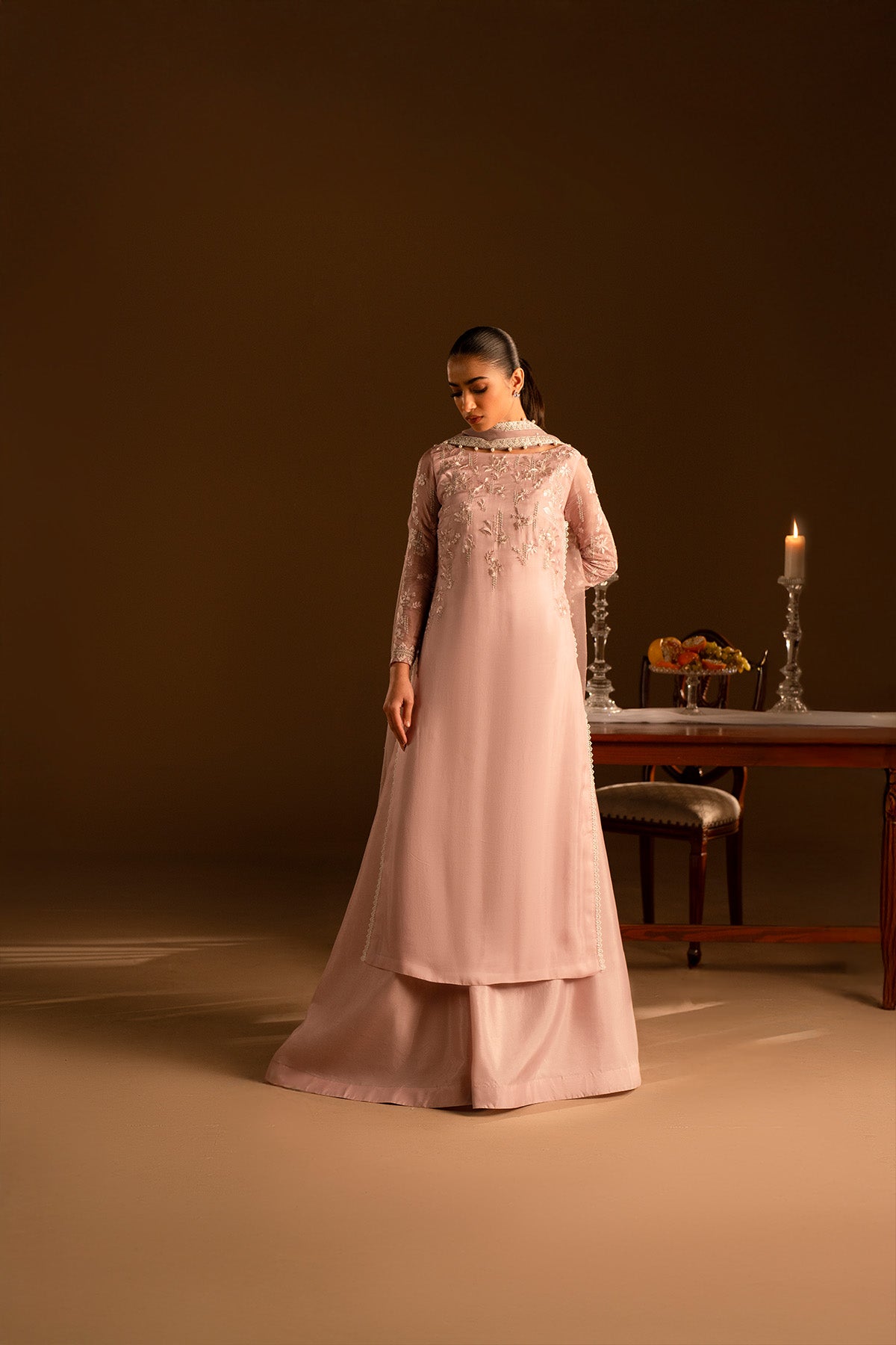 Model in a front shot wearing embroidered silk shirt and katan sharara set