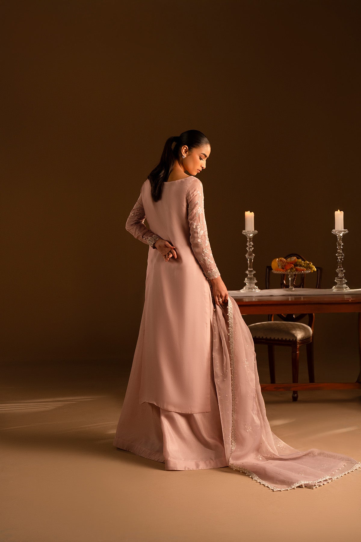 Model in a back shot wearing embroidered silk shirt and katan sharara set