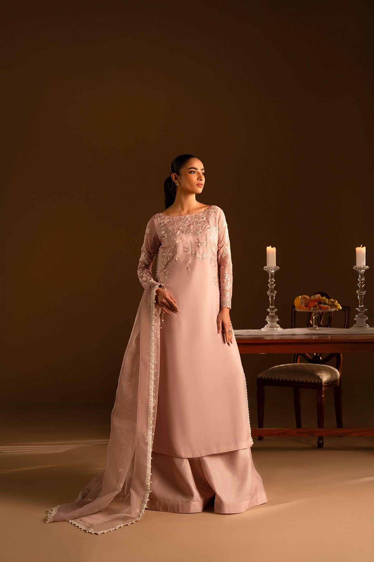 Model in a front shot wearing embroidered silk shirt and katan sharara set