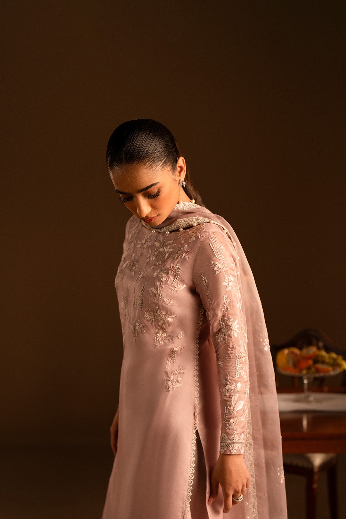 Model in a front close shot wearing embroidered silk shirt and katan sharara set