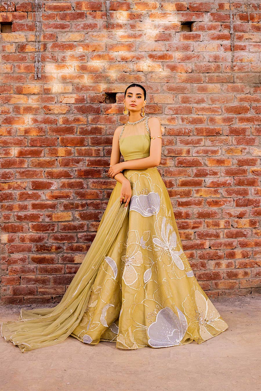 model in a front shot wearing a formal lime green lehenga paired with a blouse and dupatta