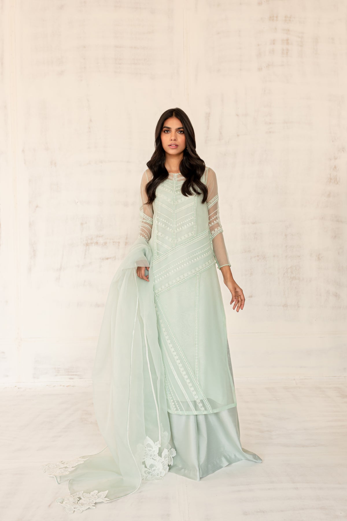 Model in a front view shot wearing a mint long organza shirt paired with an organza dupatta and silk katan pants