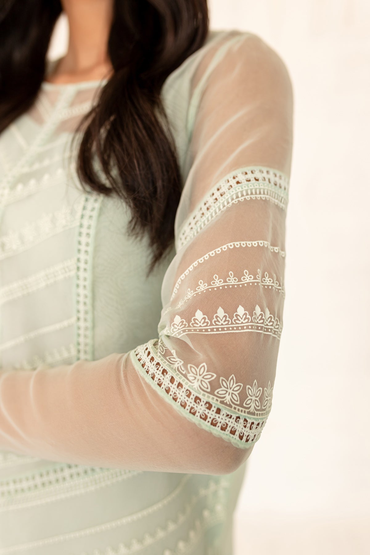 Model in a close-up shot wearing a mint long organza shirt