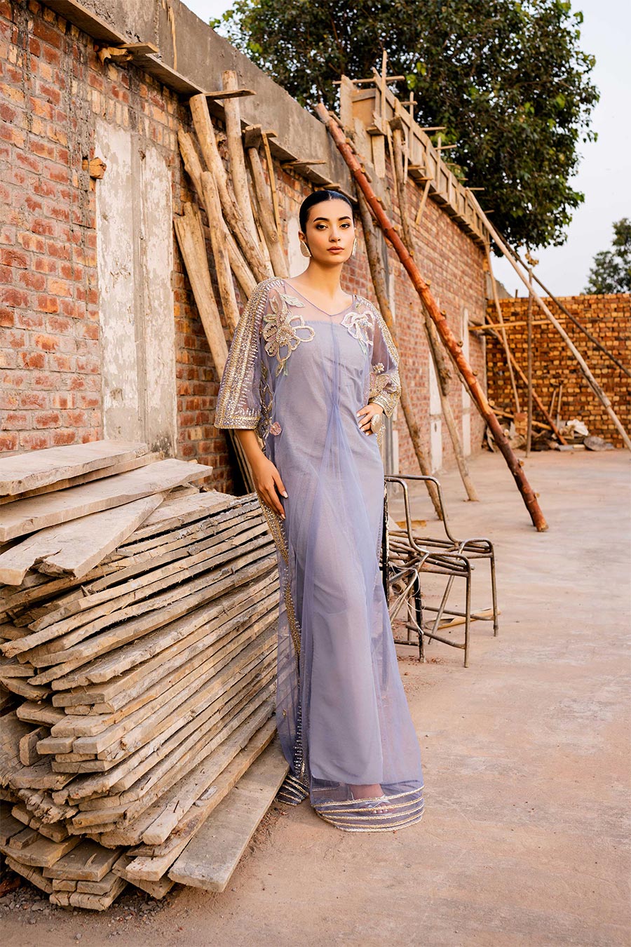 model in a front shot wearing a formal periwinkle net kaftan