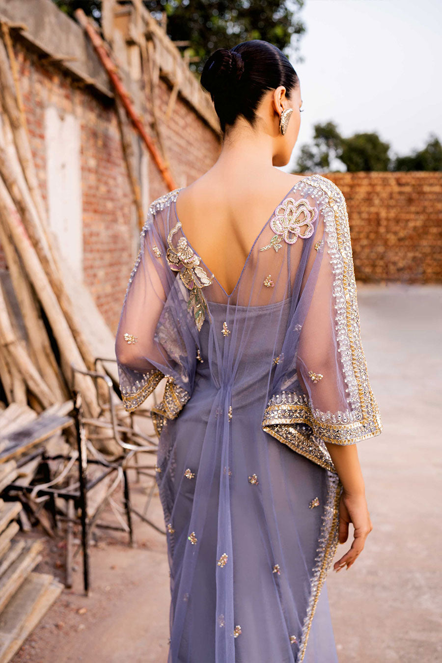 model in a back closeup shot wearing a formal periwinkle net kaftan 