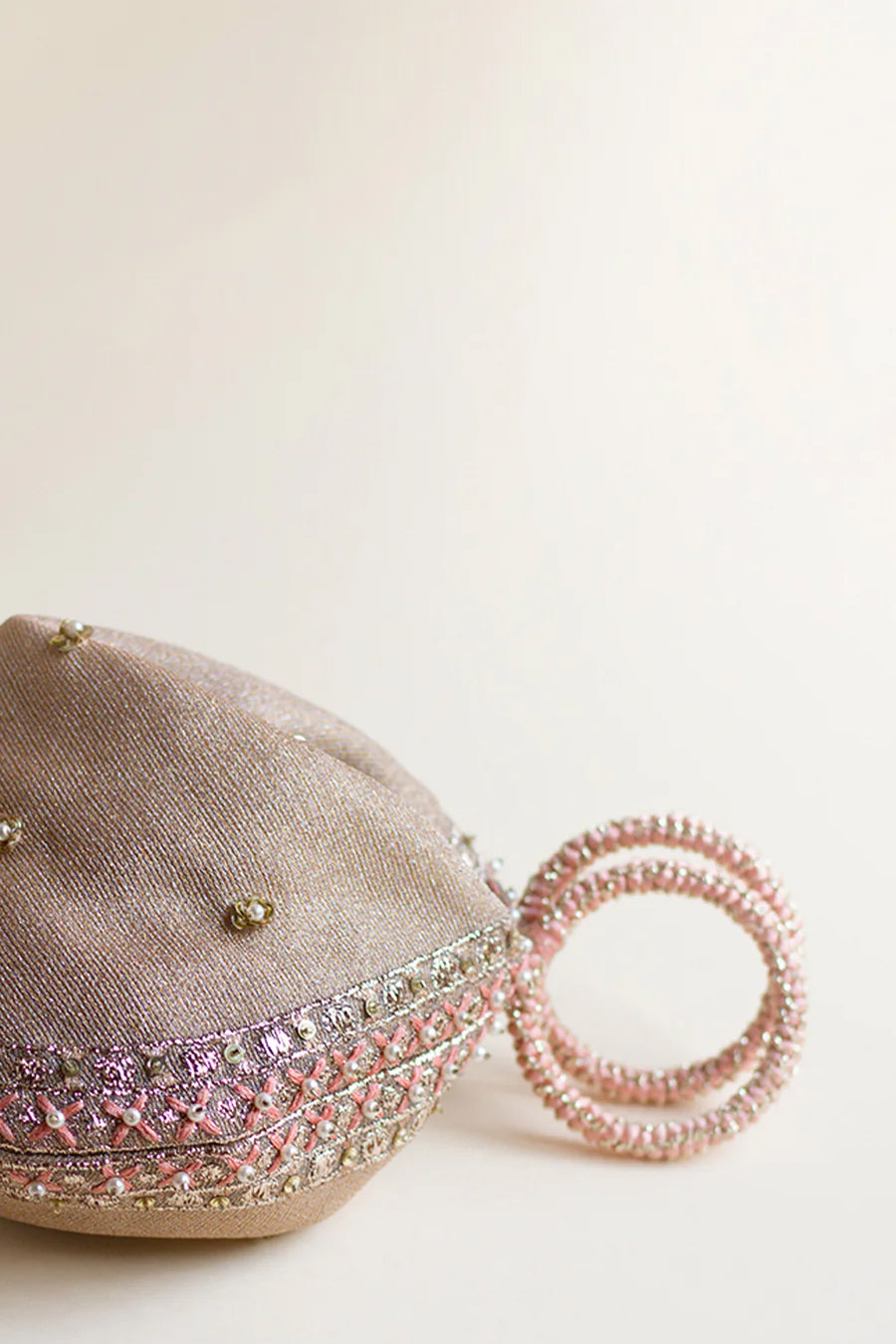 Half shot of pink zari pouch with silk thread and zardozi dori bangles