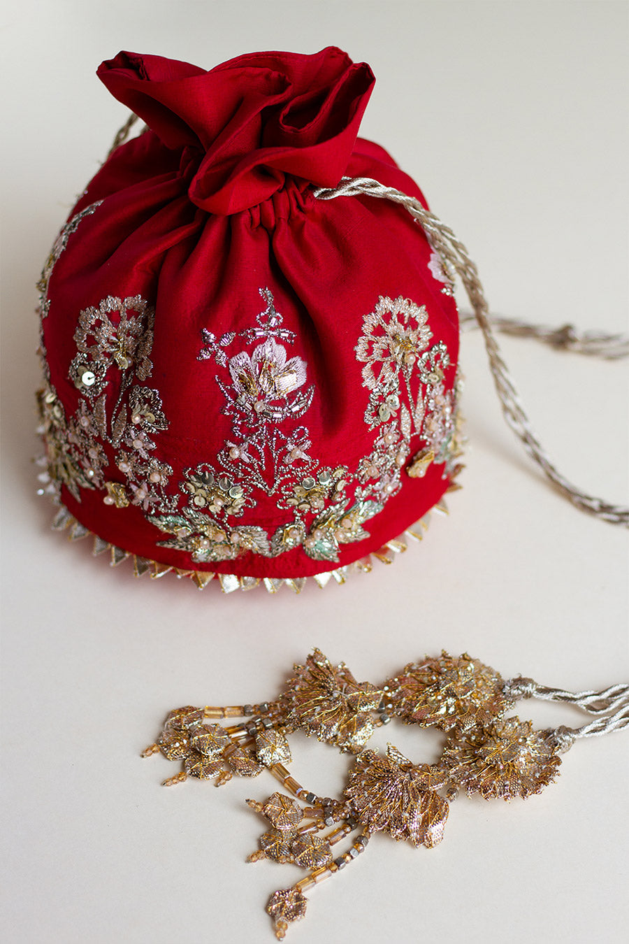 Closeup shot of red raw silk pouch golden tassels