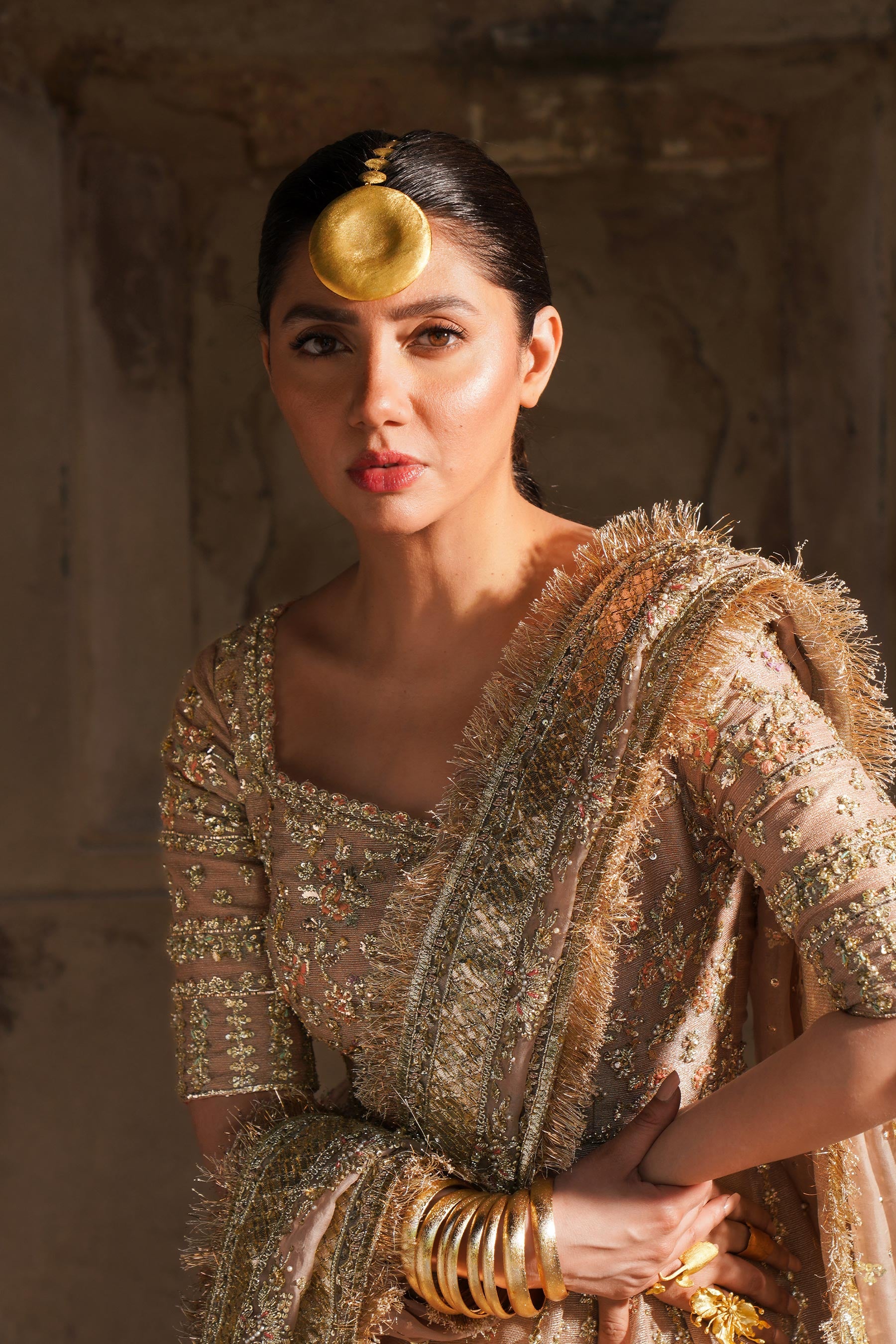 Mahira Khan in a close up shot wearing golden tikka