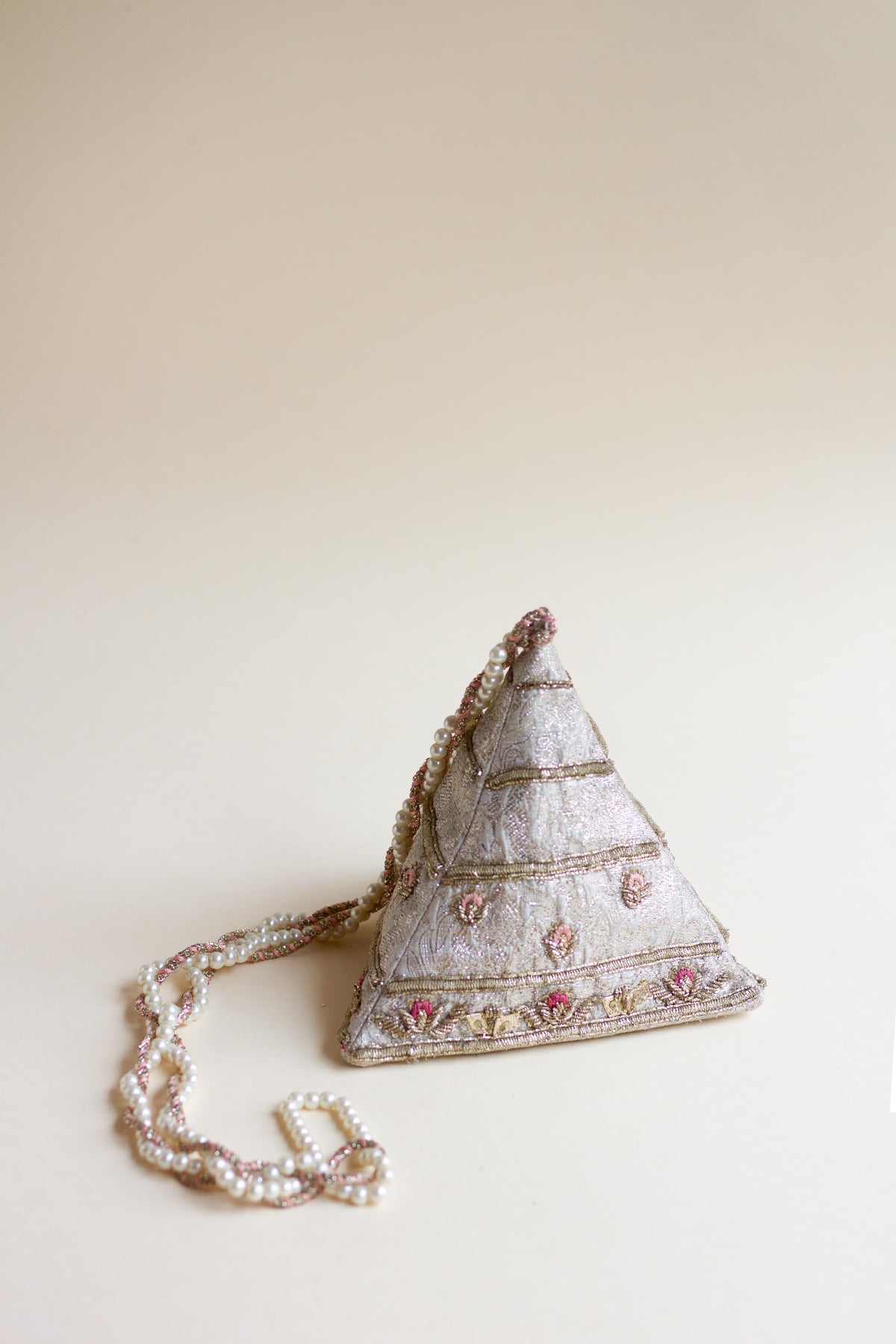 Full shot of pyramid shaped pouch made in pink tissue