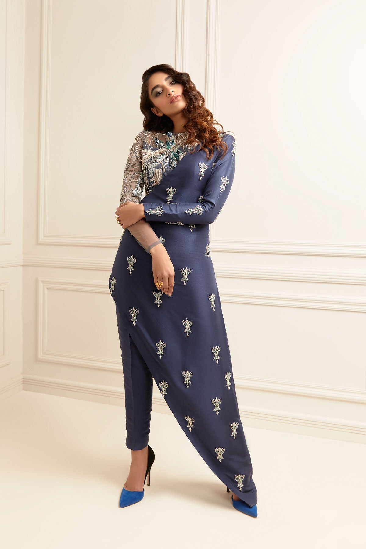 Model in a front shot wearing blue raw silk dress with side slit paired with blue raw silk pants