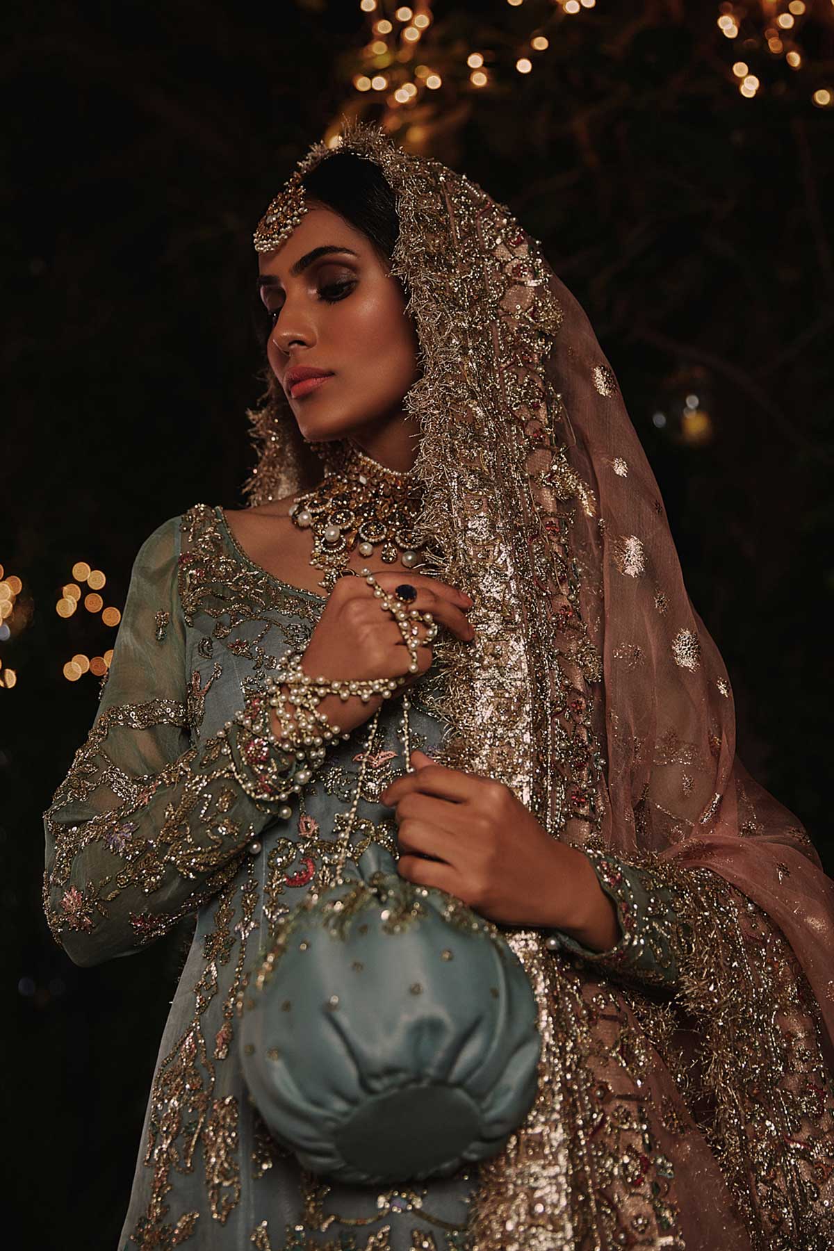 model in a front closeup shot wearing straight silk organza shirt in dusty blue color paired with silk organza gharara and organza zari dupatta 