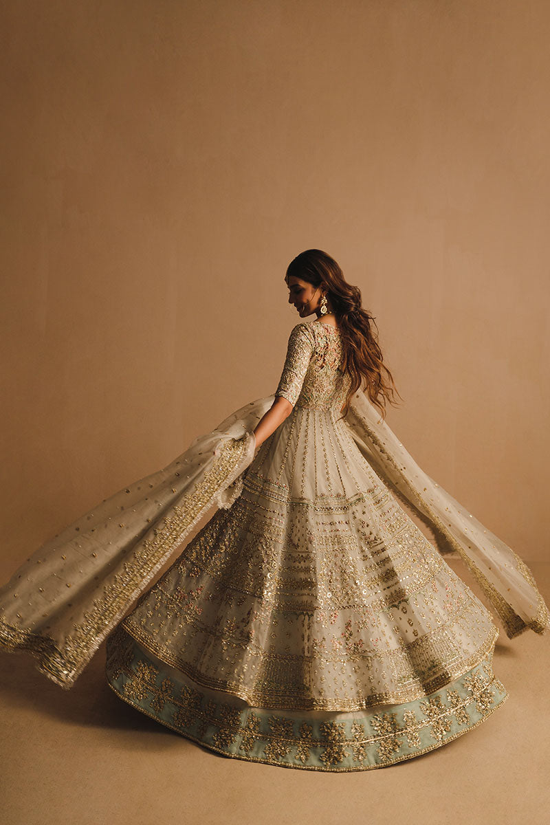 Rabia Butt in a back shot wearing white net pishwas paired with a net lehenga and organza net dupatta