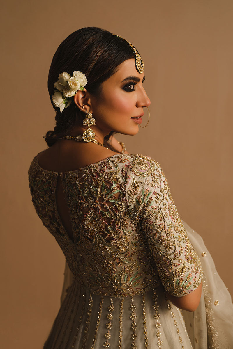 Rabia Butt in closeup back shot wearing white net pishwas paired with a net lehenga and organza net dupatta