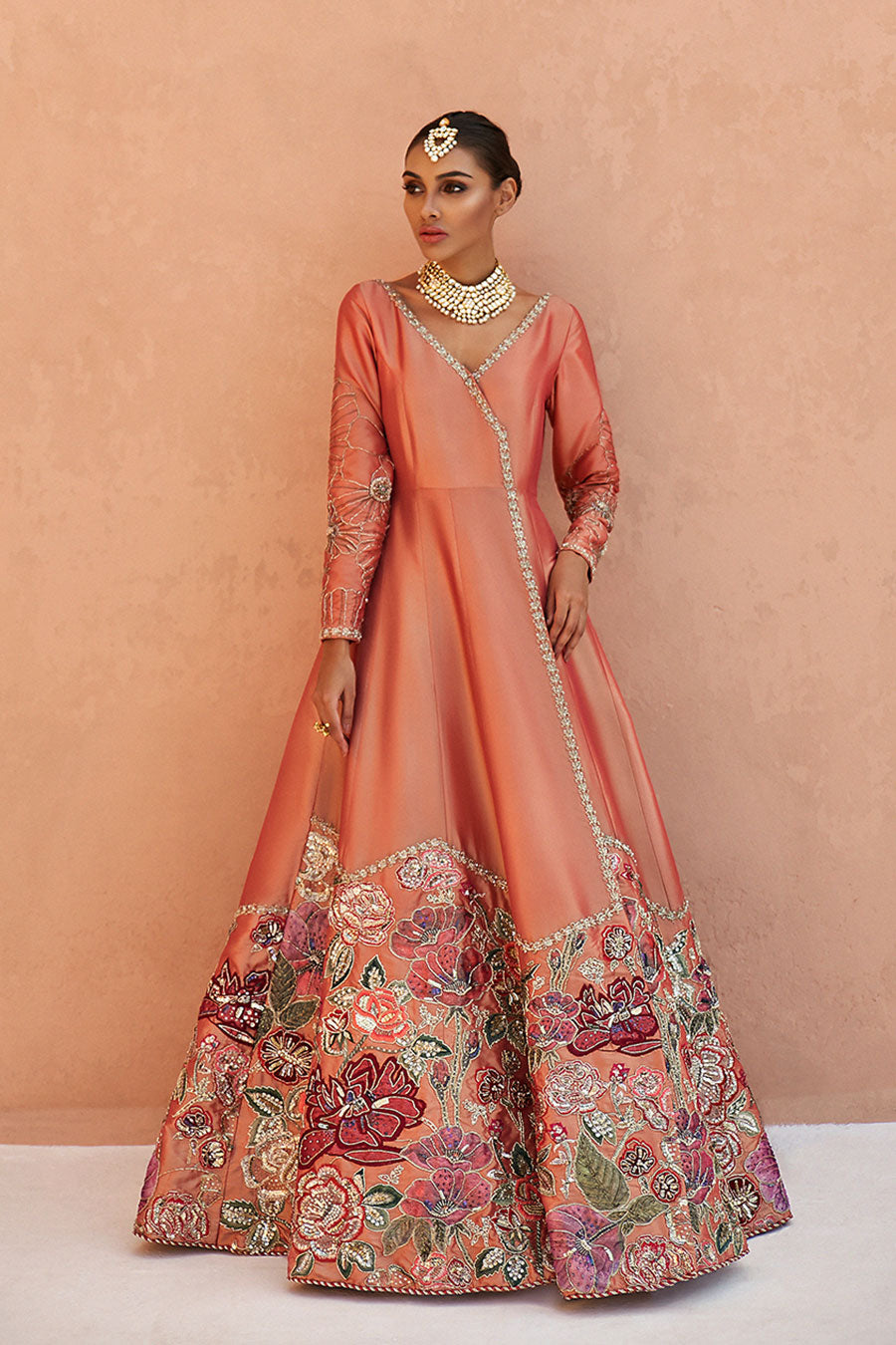 model in a front shot wearing formal  double-toned silk kattan angrakha paired with a fuchsia kattan lehenga.