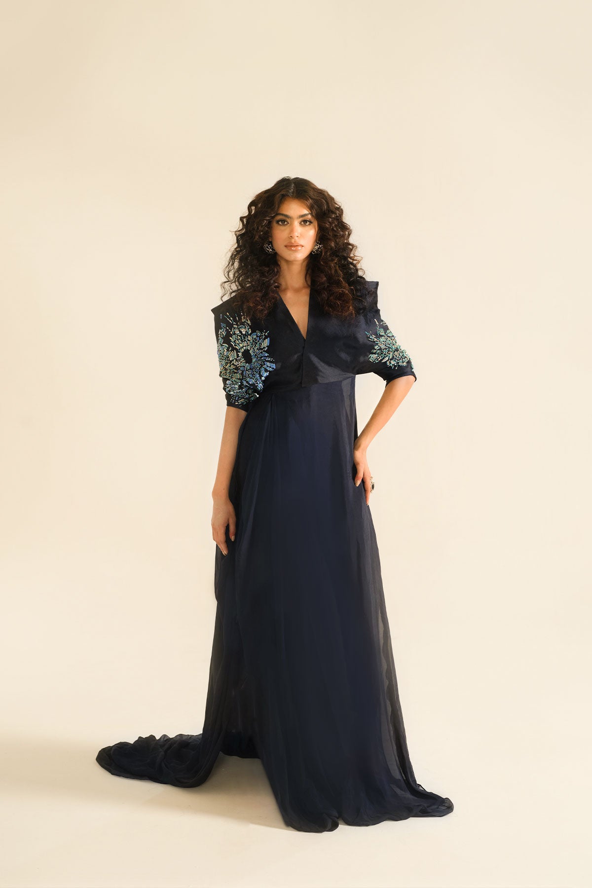 Model in a front shot wearing a silk chiffon midnight blue dress paired with cigarette tissue raw silk pants