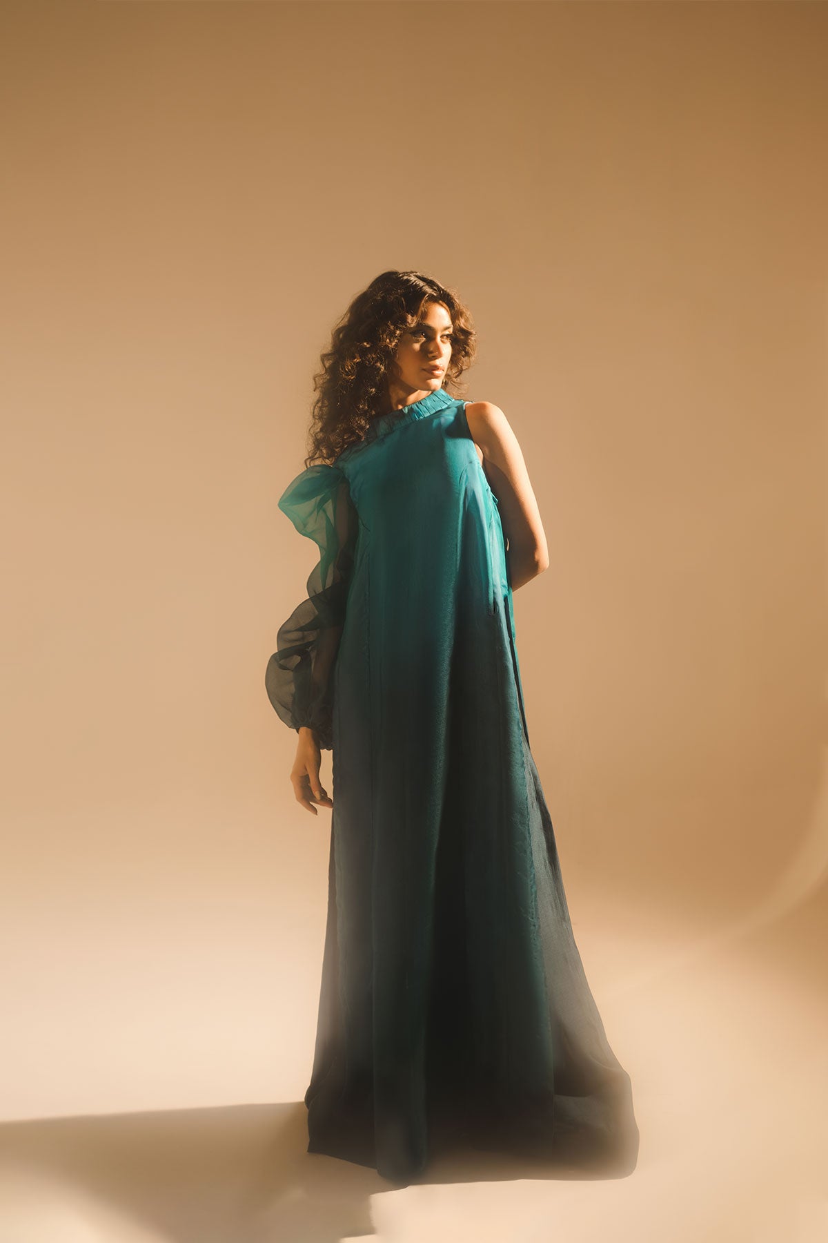 Model in a front shot wearing ombre silk organza shirt with silk organza drape attached paired with tissue silk pants