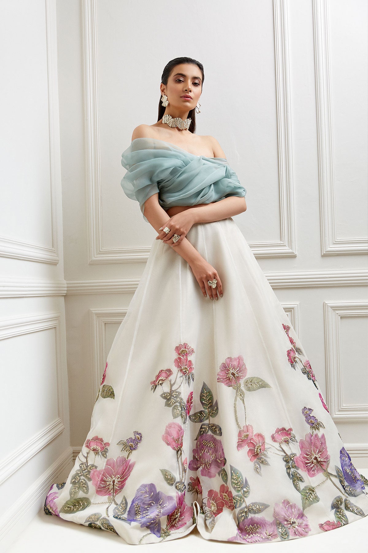 model in a front shot ivory, hand-painted floral organza skirtp aired with an off-shoulder organza blouse